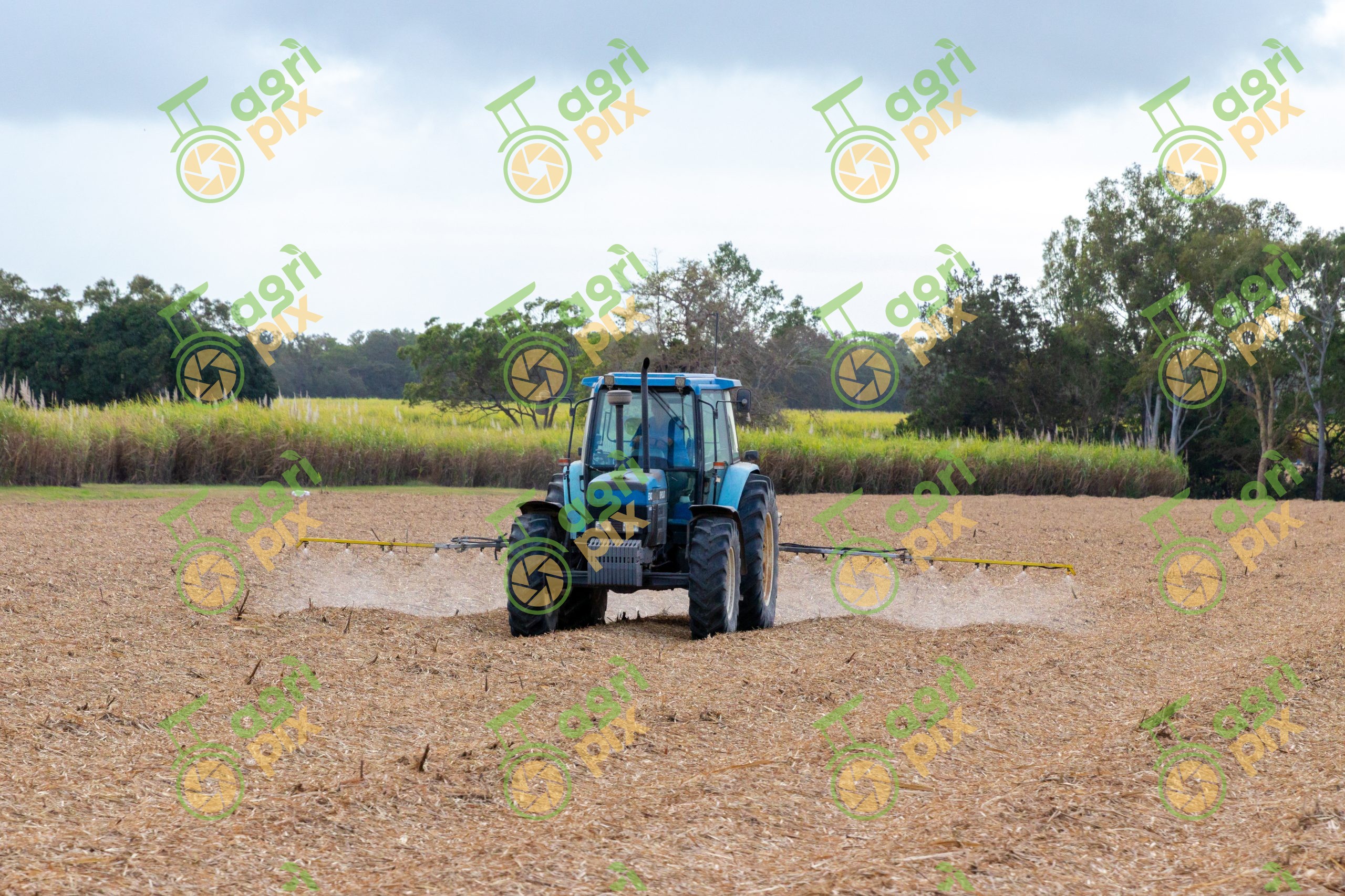 A tractor with a boom sprayer